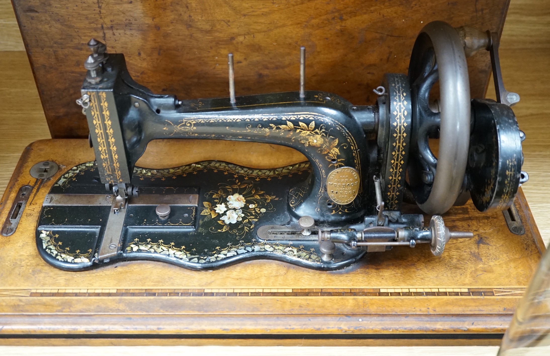 A 19th century mother of pearl decorated John Murdoch sewing machine with wooden case
